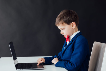 Boy in the classroom at the laptop online education skype communication