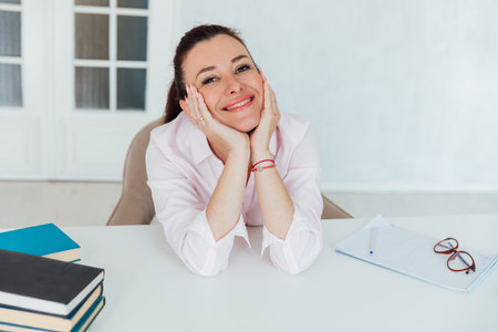 Beautiful business woman brunette at work in officeの写真素材