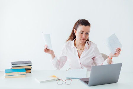Business woman at work in office with laptop at deskの写真素材