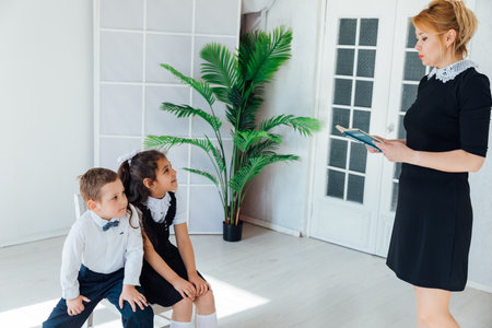 Teacher teaching children at school in lessonの写真素材