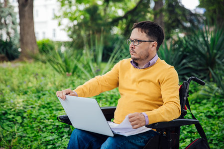 A person with with a laptop in the parkの写真素材