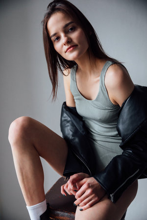 Brunette in gray bodysuit posing in studioの写真素材