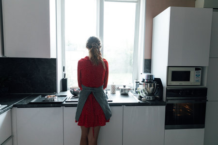 Woman in the kitchen washing dishesの写真素材