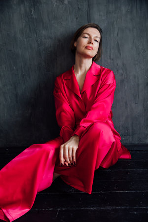 Beautiful woman in red silk pajamasの写真素材