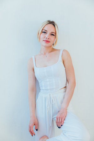 Portrait of a beautiful fashionable woman in white clothesの写真素材