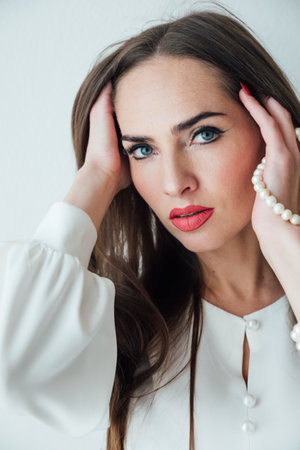 Portrait of a beautiful woman with beads on a white backgroundの写真素材