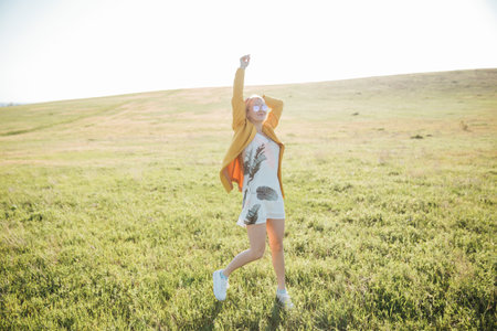 Sunny blonde in nature in the field walk journeyの写真素材