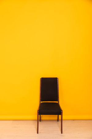 black chair on yellow background interior furniture minimalismの写真素材