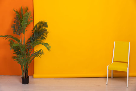 yellow chair with decorative flower on orange background interior furniture