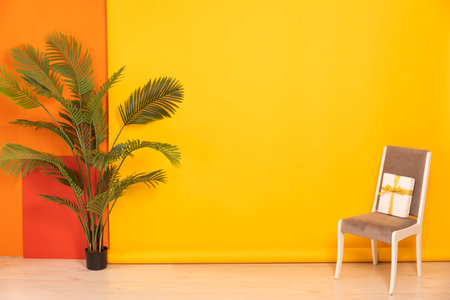 grey chair with a gift and a green tree in the interiorの写真素材