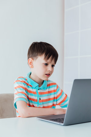 Boy with laptop online learning internet jobの写真素材