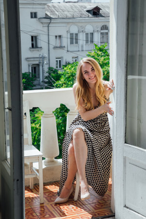 Portrait of beautiful fashionable blonde woman in light summer dressの写真素材