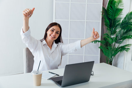 Business woman enjoying working in office with laptopの写真素材