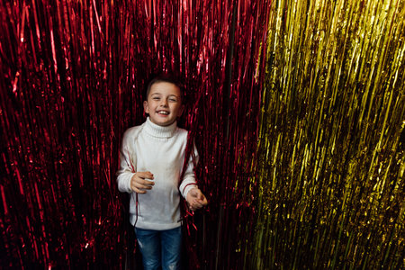 Little boy smiling at the red yellow wallの写真素材