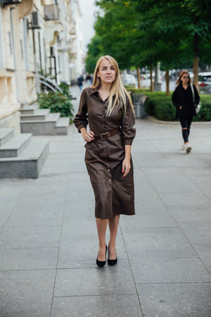 a blonde woman walking down the street for a walk restの写真素材