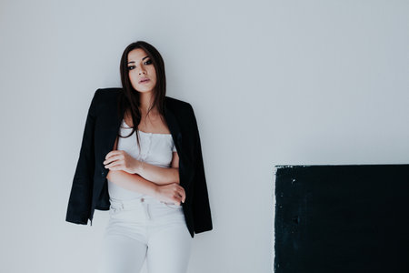 a business woman stands on a white black backgroundの写真素材