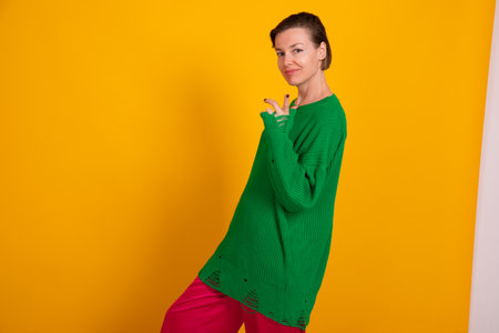 Beautiful slender woman in green knitted autumn sweaterの写真素材