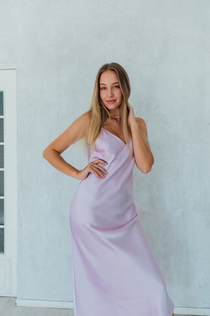 Beautiful slender fashionable woman in summer silk dressの写真素材