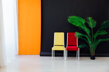 Interior of a black and orange room with colored chairs, armchairsの写真素材
