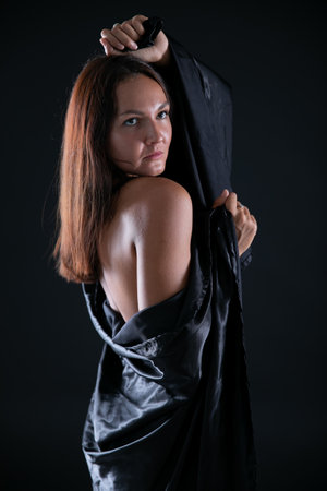 Brunette woman posing on black background in studioの写真素材