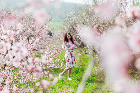 spring nature travel walk beautiful woman brunette in flowering treesの写真素材