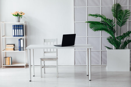 An office space with a laptop on the tableの写真素材