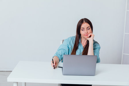 Business woman working online at computer in officeの写真素材