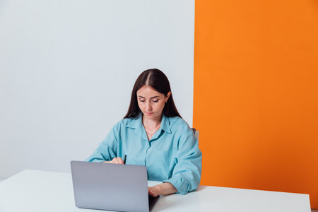 Woman in office working on laptopの写真素材