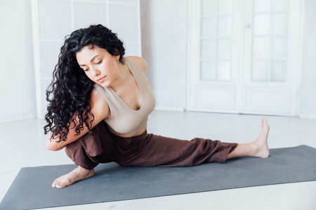 Female yogi doing asana pose gymnastics exercisesの写真素材