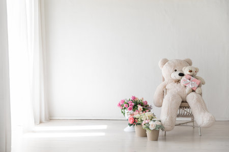 Interior of a white room with flowers and a polar bear toyの写真素材