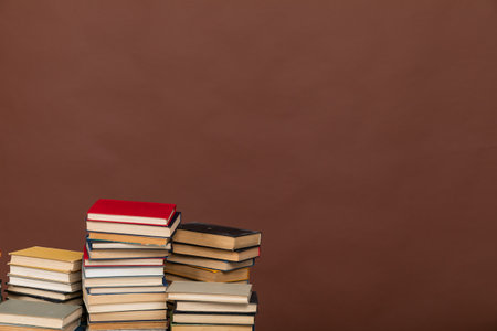 Many stacks of educational books to study in the university library on a backgroundの写真素材