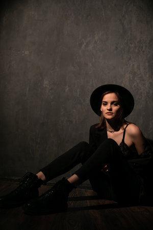 Portrait of a beautiful young woman in black clothes at nightの写真素材