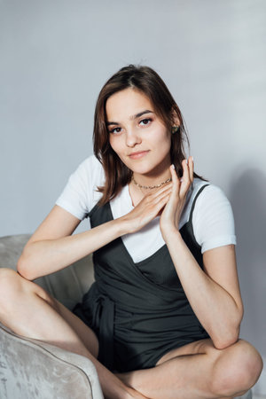 Portrait of a beautiful young woman in a black and white summer dress
