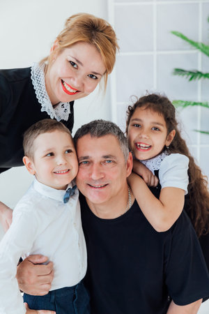 Family photo of mom with dad and son with daughter