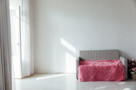 Grey pink office sofa in white room interior with windowの写真素材