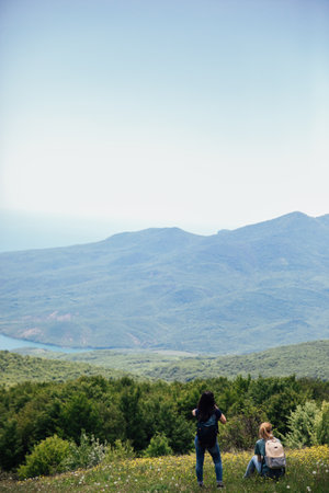 Tourist traveler on top of mountain looking at landscapeの写真素材