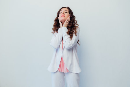 Beautiful woman brunette emotion portrait on white backgroundの写真素材