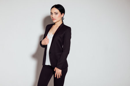 Business beautiful woman in brown business suit in officeの写真素材