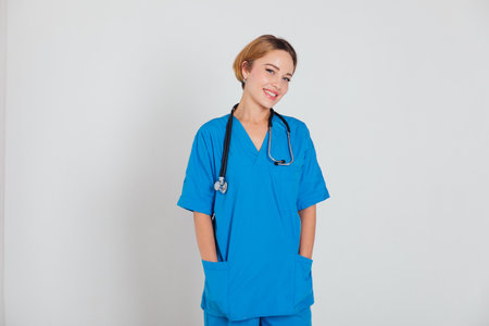 Beautiful female doctor with stethoscope in medical hospitalの写真素材