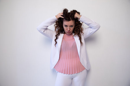 Beautiful brunette woman shaggy hair on white backgroundの写真素材