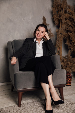 Business woman in suit at desk in officeの写真素材