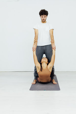 Smiling couple doing yoga exercises outdoorsの写真素材