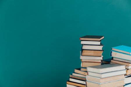 Lots of stacks of old books on green background, school libraryの写真素材