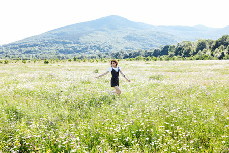Walk Journey Woman in Field in Flowers in Natureの写真素材