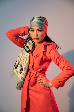 Fashionable woman in headscarf posing in studioの写真素材