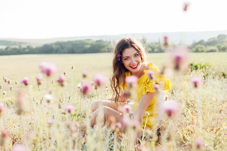 Woman in a field with flowers on a walk journeyの写真素材