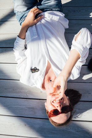 Beautiful slender woman walking in the park on the coastの写真素材