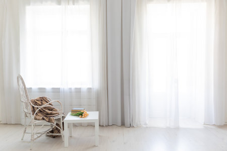 Coffee table with flowers and vintage armchair in white room interiorの写真素材
