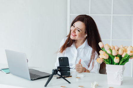 Woman running online small business with laptop