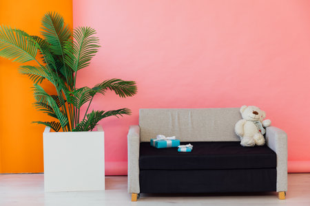 Black and grey office sofa in the interior of a multicolored roomの写真素材